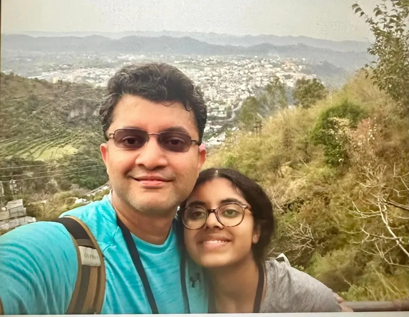 Ananya and her Dad taking a selfie above the valley at Ardhkuwari