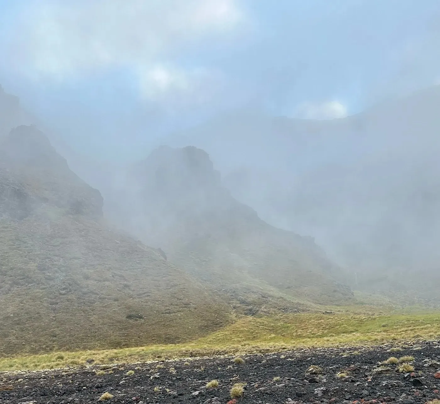 Volcanic ridges disappearing into thick cloud